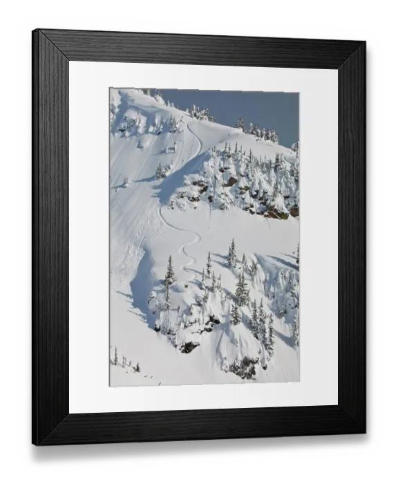 Framed Print : A male backcountry snowboarder sprays some powder in the Revelstoke Mountain Backcountry, BC
