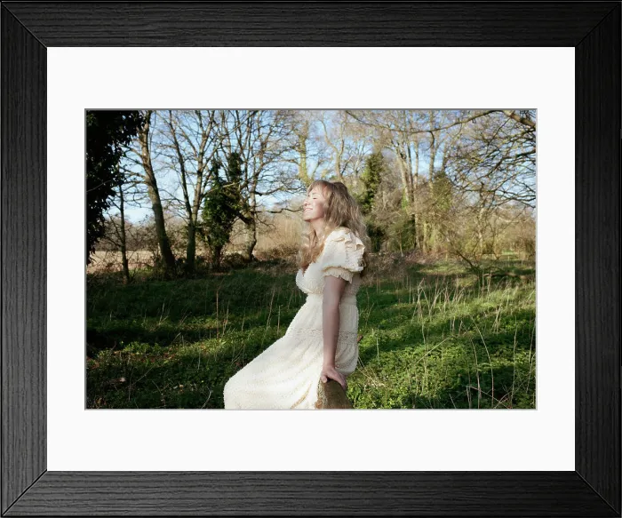 Framed Print : woman sat on a gate in a field enjoying the summer sun Framed Print : woman sat on a gate in a field enjoying the summer sun