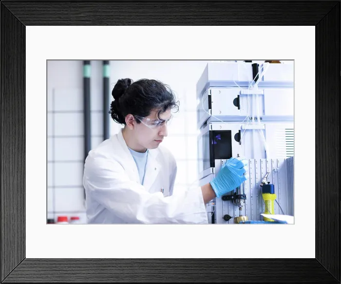 Framed Print : A focused scientist operating laboratory equipment Framed Print : A focused scientist operating laboratory equipment