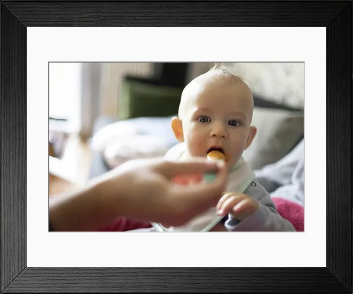 Framed Print : Child is fed with porridge, Bonn, Germany, Europe Framed Print : Child is fed with porridge, Bonn, Germany, Europe