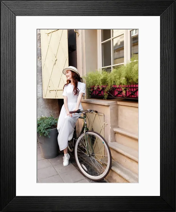 Framed Print : tourist in a hat and a light dress in summer European city