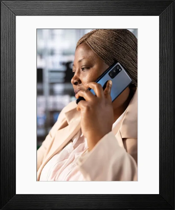 Framed Print : CEO in office talking on phone with partners Framed Print : CEO in office talking on phone with partners