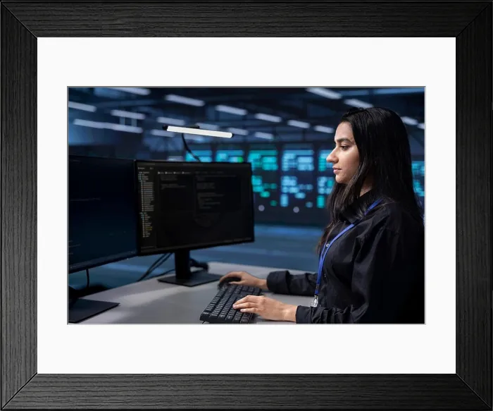 Framed Print : Software programmer in server farm tasked to oversee mainframes devices used for managing databases Framed Print : Software programmer in server farm tasked to oversee mainframes devices used for managing databases
