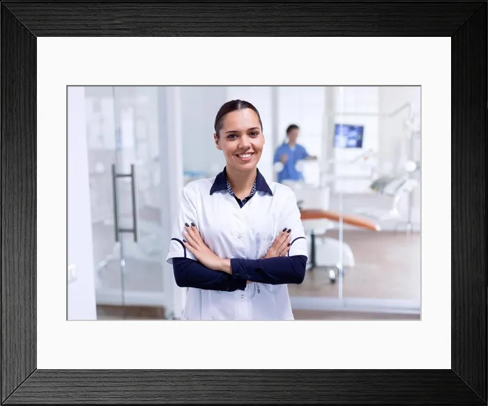 Framed Print : Portrait of cheerful dentist in dental reception Framed Print : Portrait of cheerful dentist in dental reception