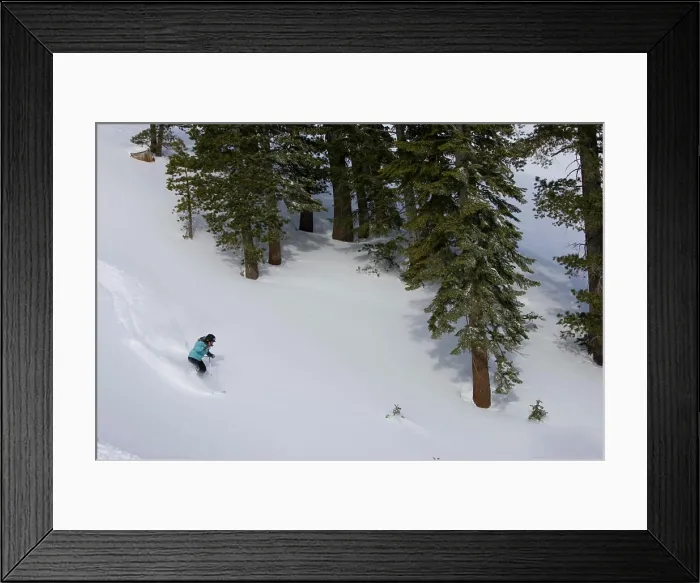 Framed Print : A skier descends a snowy slope through deep powder on a beautiful day in Kirkwood, California