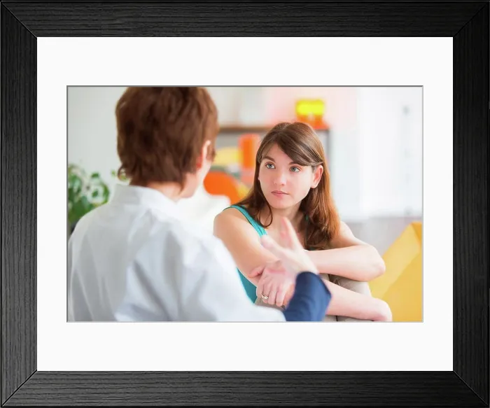 Framed Print : Medical consultation, Doctor talking with a female patient Framed Print : Medical consultation, Doctor talking with a female patient
