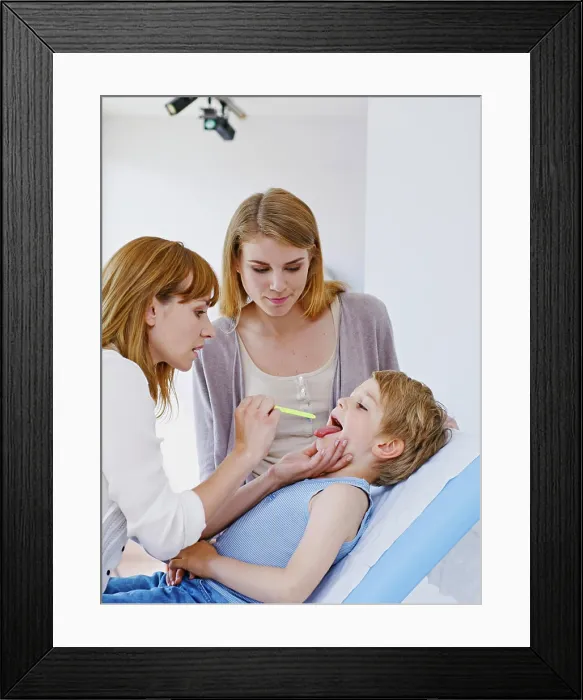 Framed Print : Doctor examining a child's throat Framed Print : Doctor examining a child's throat