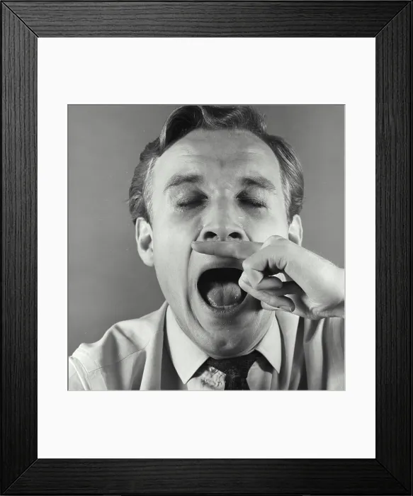 Framed Print : Close-up of a mature man sneezing