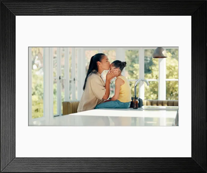 Framed Print : Kiss, mother and daughter with getting ready in home on kitchen table with backpack and greeting Framed Print : Kiss, mother and daughter with getting ready in home on kitchen table with backpack and greeting