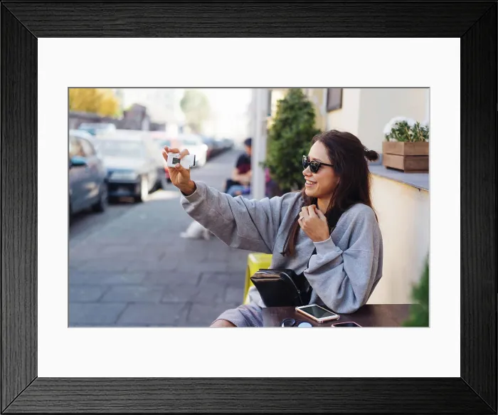 Framed Print : Cute, young female blogger posing on camera Framed Print : Cute, young female blogger posing on camera