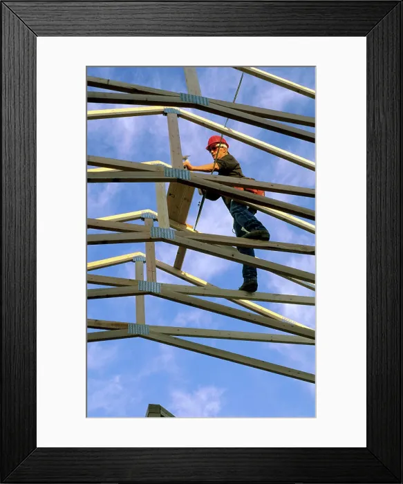 Framed Print : Construction worker using wood trusses for roof frame in Boise, Idaho Framed Print : Construction worker using wood trusses for roof frame in Boise, Idaho