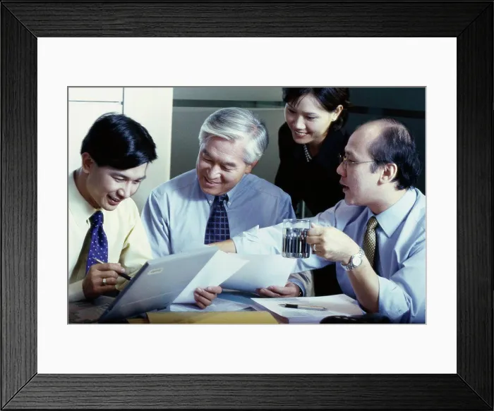 Framed Print : Business executives in a meeting