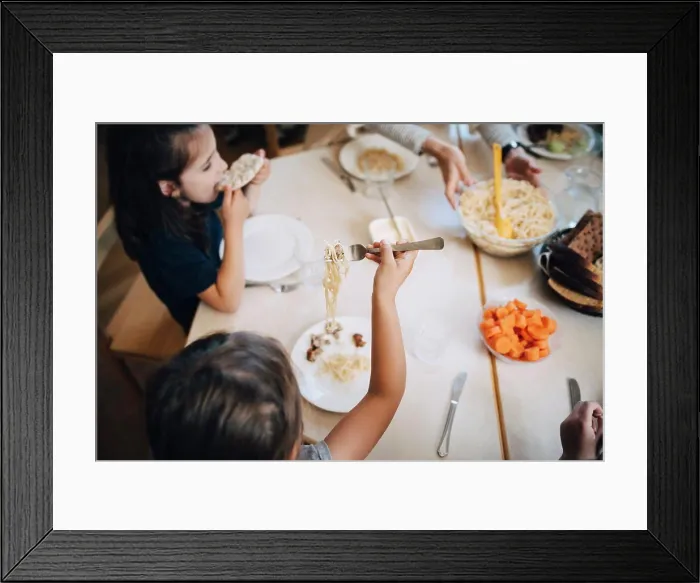 Framed Print : High angle view of students eating lunch while sitting at table in classroom