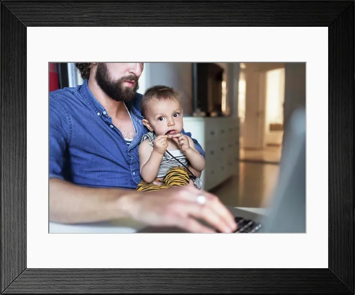 Framed Print : Portrait of baby boy with father using laptop at home Framed Print : Portrait of baby boy with father using laptop at home