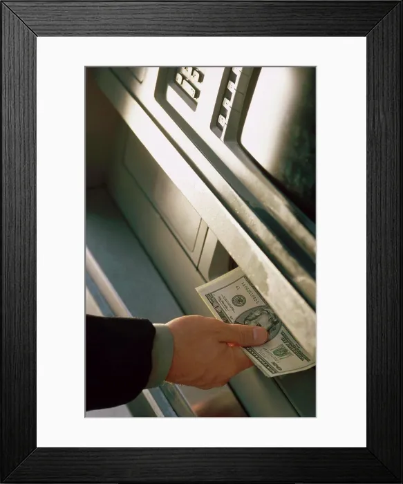 Framed Print : Person withdrawing cash from an ATM Framed Print : Person withdrawing cash from an ATM