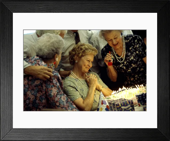 Framed Print : Group of senior people celebrating at a birthday party Framed Print : Group of senior people celebrating at a birthday party