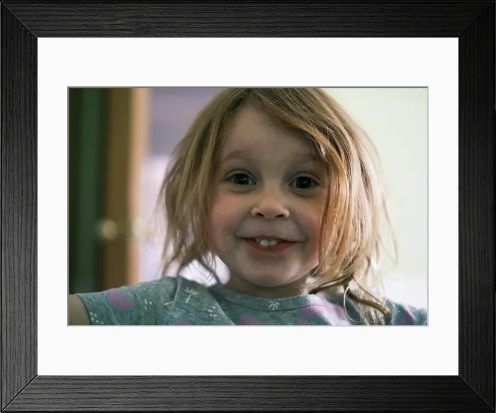 Framed Print : Happy child smiling directly at camera Framed Print : Happy child smiling directly at camera
