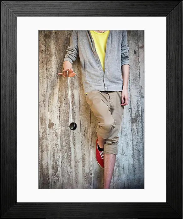 Framed Print : Young man playing with a yo-yo Framed Print : Young man playing with a yo-yo