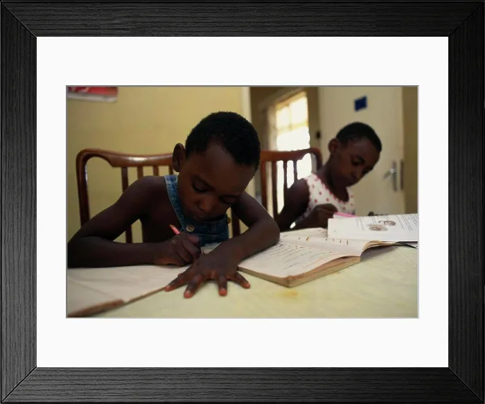 Framed Print : Uganda, Kampala, Two Young Children Doing Homework Framed Print : Uganda, Kampala, Two Young Children Doing Homework