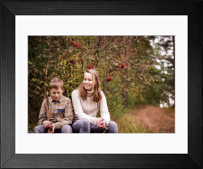 Framed Print : Two blond teenagers, a girl and a boy, a sister and a brother sit in the autumn forest and have fun chatting Framed Print : Two blond teenagers, a girl and a boy, a sister and a brother sit in the autumn forest and have fun chatting