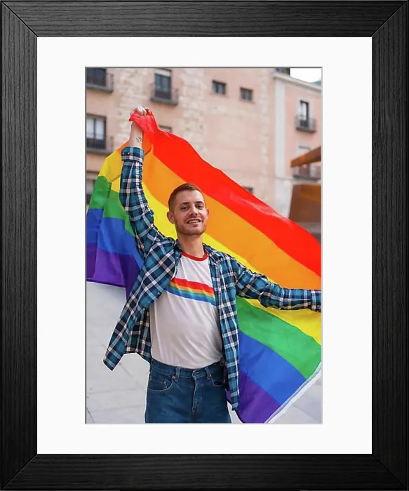 Framed Print : Portrait of gay man with rainbow lgbt flag in the city, pride party and homosexual Framed Print : Portrait of gay man with rainbow lgbt flag in the city, pride party and homosexual