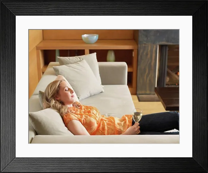 Framed Print : Woman Relaxing on Sofa Framed Print : Woman Relaxing on Sofa