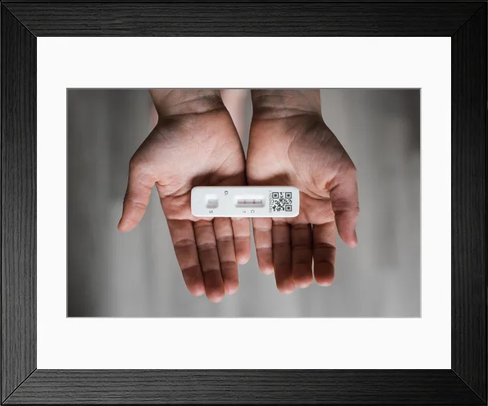 Framed Print : child's hands holding a positive COVID Lateral flow test Framed Print : child's hands holding a positive COVID Lateral flow test