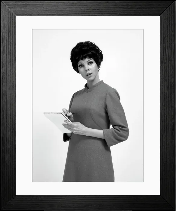 Framed Print : Studio portrait of secretary holding notepad Framed Print : Studio portrait of secretary holding notepad