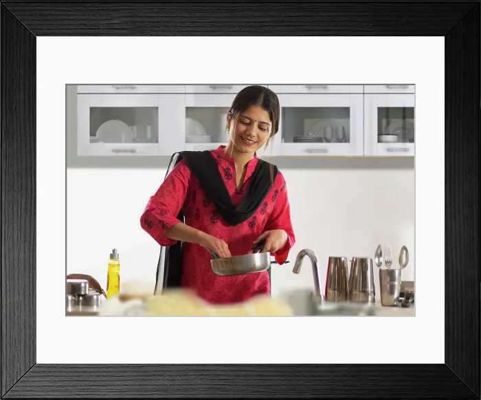 Framed Print : Cheerful woman washing a frying pan in kitchen at home Framed Print : Cheerful woman washing a frying pan in kitchen at home