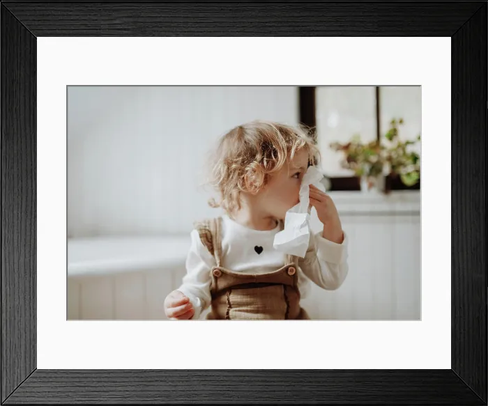 Framed Print : Sick girl with cold at home, blowing her nose. Sick girl with cold at home, blowing her nose model released