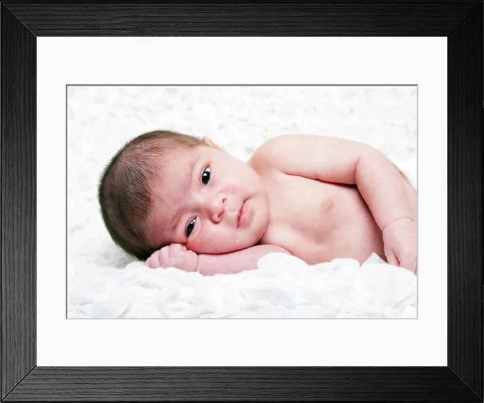 Framed Print : Cute baby face Cute Caucasian Hispanic infant baby with big eyes laying on side on soft white cotton cloud with hand Framed Print : Cute baby face Cute Caucasian Hispanic infant baby with big eyes laying on side on soft white cotton cloud with hand