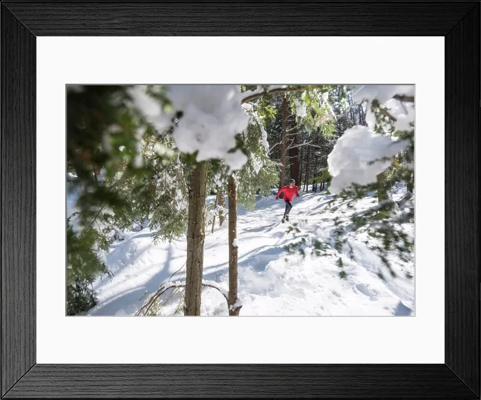 Framed Print : A male athlete trail running on a winter day Framed Print : A male athlete trail running on a winter day