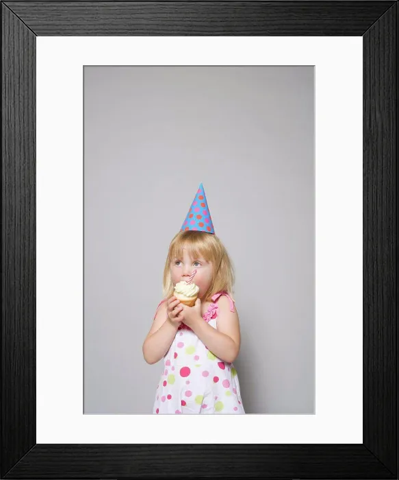 Framed Print : Girl eating a cupcake Framed Print : Girl eating a cupcake