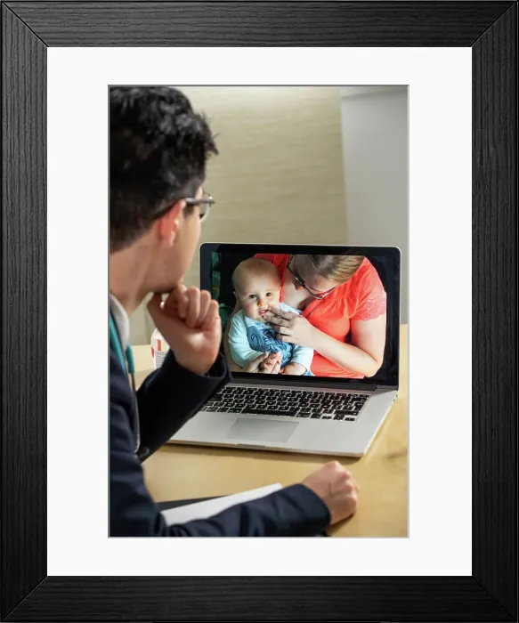 Framed Print : Pediatrician in remote consultation with mother and infant with skin irritation Framed Print : Pediatrician in remote consultation with mother and infant with skin irritation