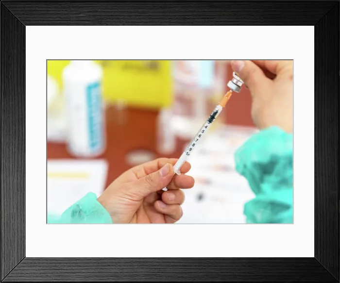Framed Print : Nurse preparing a dose of vaccine to vaccinate against Covid Framed Print : Nurse preparing a dose of vaccine to vaccinate against Covid