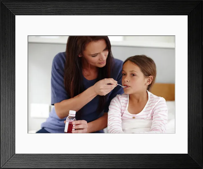 Framed Print : Mom, sick girl and medicine with spoon in bed for fever