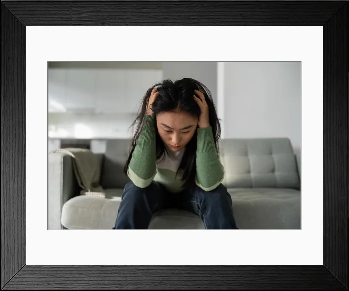 Framed Print : Unhappy depressed young Asian woman feeling sad