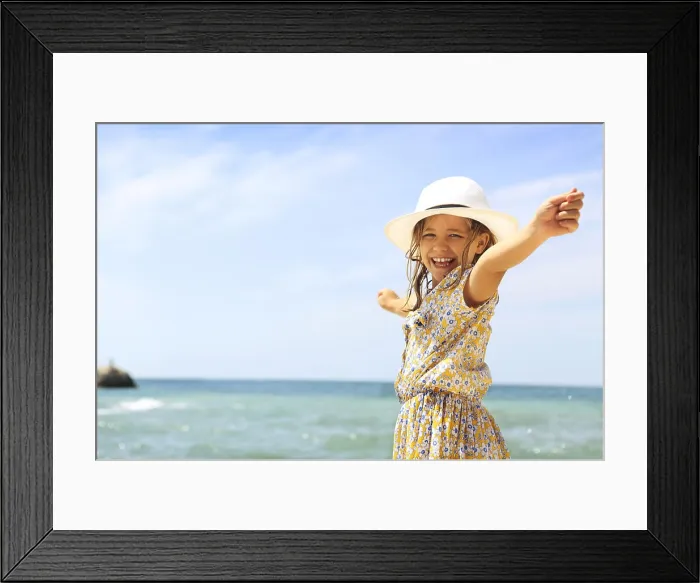 Framed Print : Summer vacation concept. Smiling girl with arms wide open Framed Print : Summer vacation concept. Smiling girl with arms wide open
