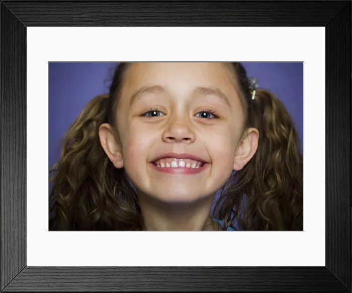 Framed Print : Close-up of a girl smiling Framed Print : Close-up of a girl smiling