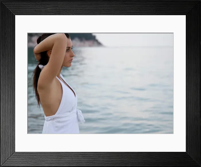 Framed Print : Portrait of young woman standing on beach Framed Print : Portrait of young woman standing on beach