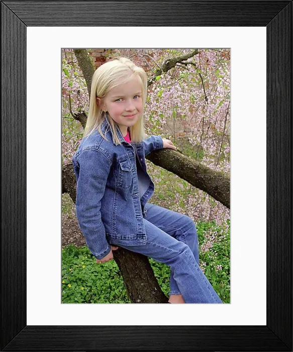 Framed Print : Blond girl sitting on tree branches Framed Print : Blond girl sitting on tree branches
