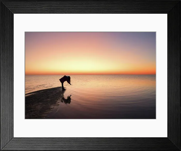 Framed Print : Silhouette young girl pointing at reflection in water at sunset Framed Print : Silhouette young girl pointing at reflection in water at sunset
