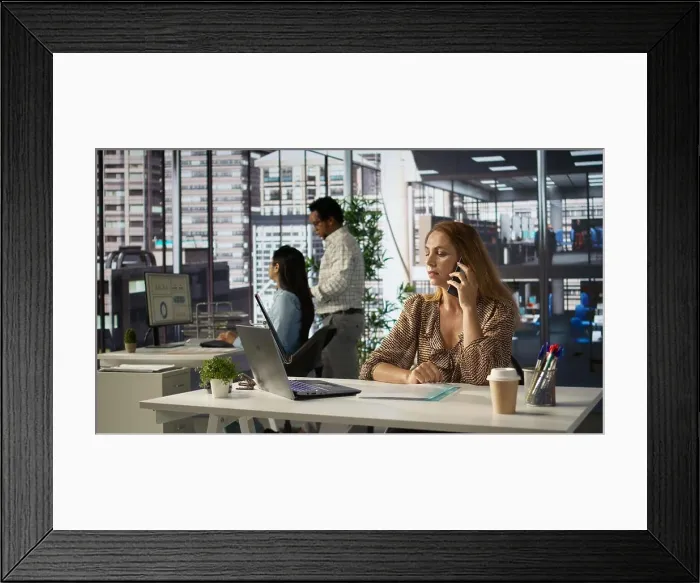 Framed Print : General manager talking about a growth plan on her smartphone Framed Print : General manager talking about a growth plan on her smartphone