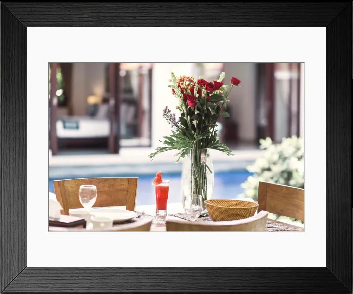 Framed Print : Flower bouquet at the table and pool in background Framed Print : Flower bouquet at the table and pool in background