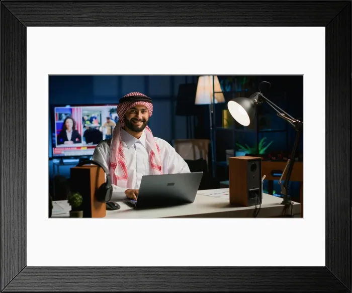 Framed Print : Portrait of happy Arab freelancer solving tasks while working from home Framed Print : Portrait of happy Arab freelancer solving tasks while working from home