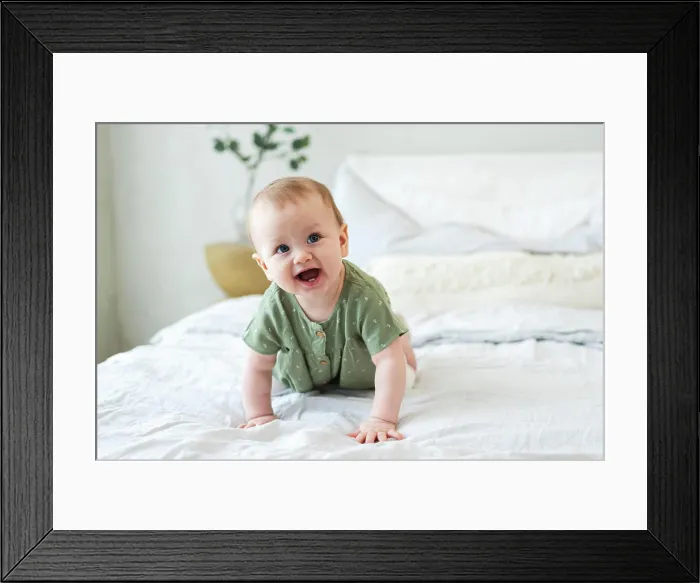 Framed Print : Happy baby. Nice little newborn girl with a smiling face crawls on the bed in the bedroom Framed Print : Happy baby. Nice little newborn girl with a smiling face crawls on the bed in the bedroom