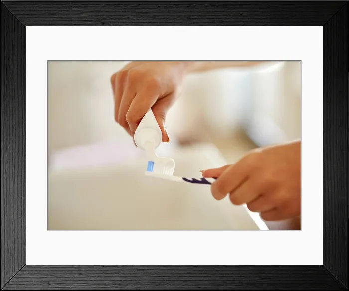 Framed Print : Toothpaste, hands and brush for dental health in bathroom with morning hygiene routine at home Framed Print : Toothpaste, hands and brush for dental health in bathroom with morning hygiene routine at home