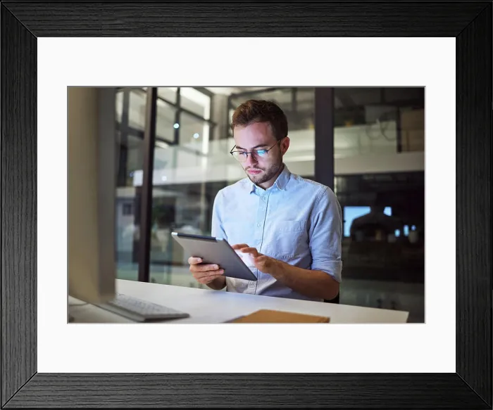 Framed Print : Tablet planning, night research and businessman working on the internet in a dark office at work