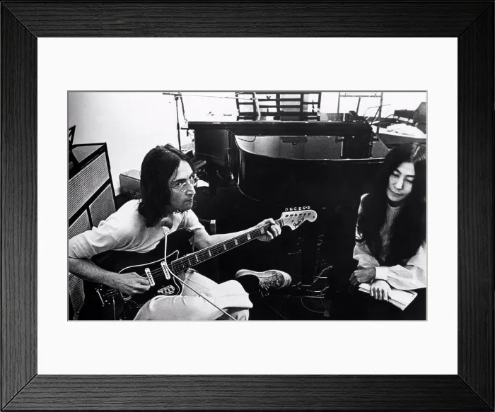 Framed Print : British singer, musician and member of The Beatles John Lennon playing guitar beside his wife Framed Print : British singer, musician and member of The Beatles John Lennon playing guitar beside his wife