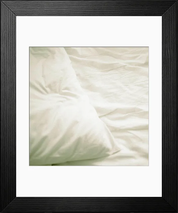 Framed Print : A pillow on a bed